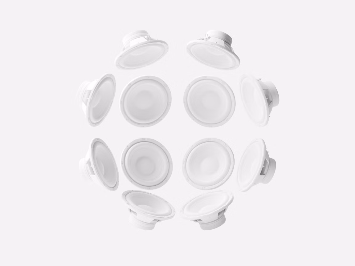 Arrangement of ten white speaker drivers forming a circular pattern viewed from above, minimalist design on a light gray background representing immersive surround sound concept.