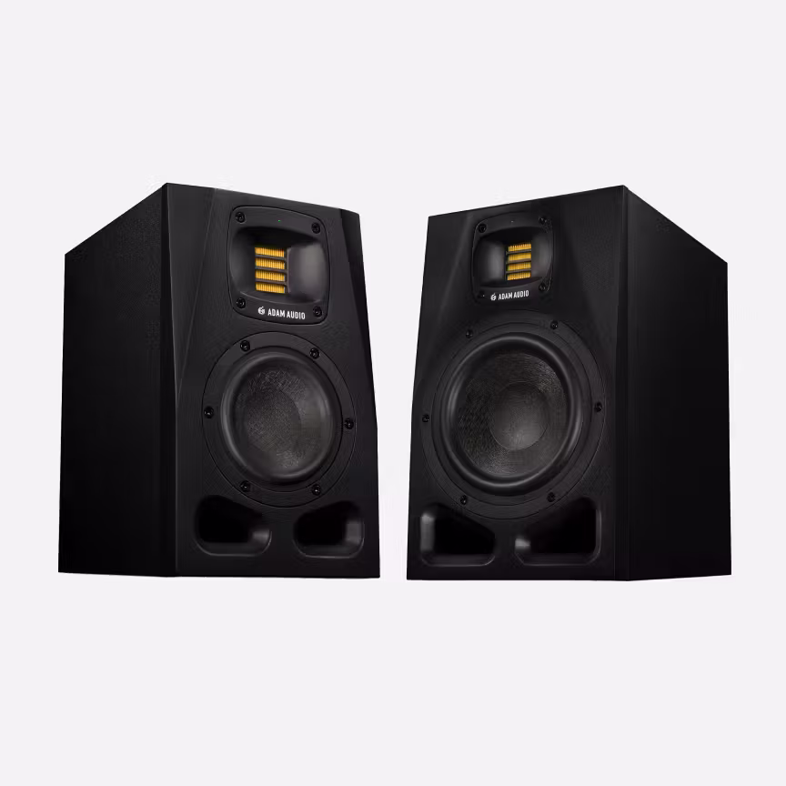 Pair of Adam Audio A-Series black studio monitors with large woofers and yellow ribbon tweeters, angled slightly toward each other on a light gray background.