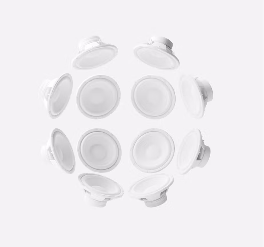 3D render of white studio speakers arranged in a circular sphere formation, symbolizing immersive surround sound environment.